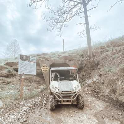 a truck driving down a dirt road