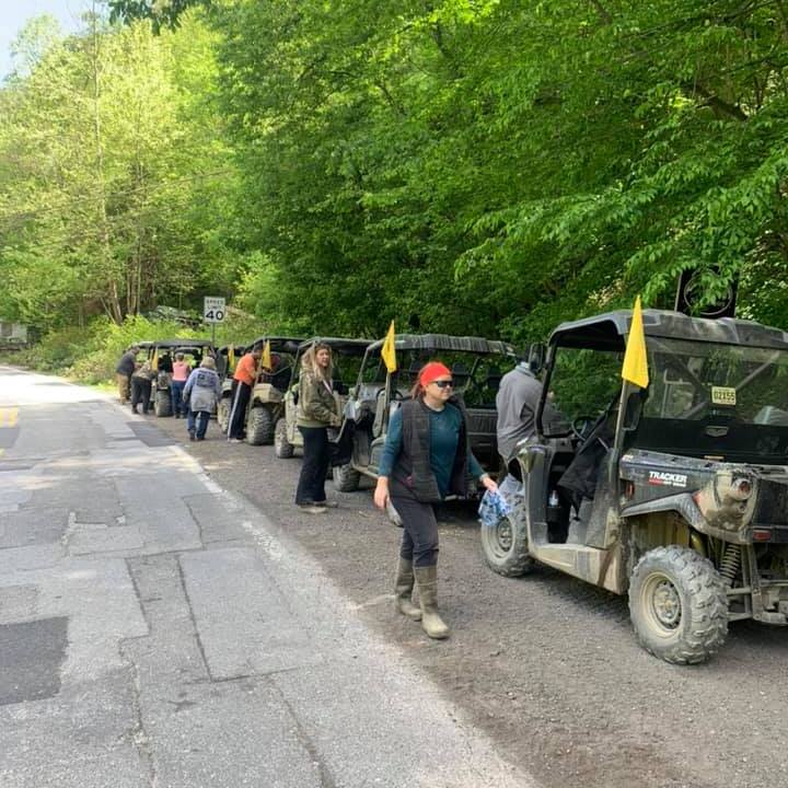 a group of people riding on the back of a truck
