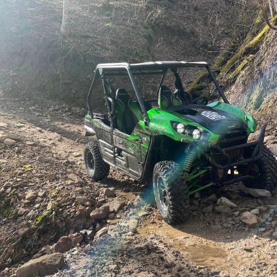 a truck driving down a dirt road
