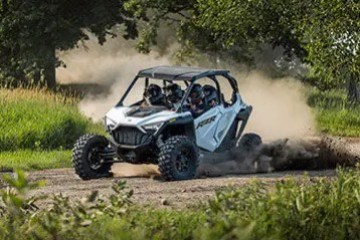 a car driving down a dirt road